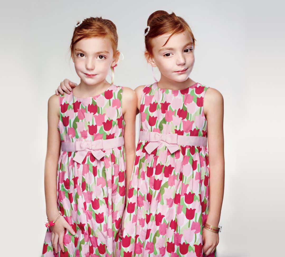 Six-year-old Johanna Gill puts a protective hand on her sister, Eva. The twins both have mild autism, a disorder linked to genetic inheritance.