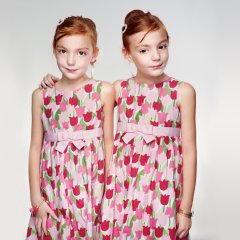 Six-year-old Johanna Gill puts a protective hand on her sister, Eva. The twins both have mild autism, a disorder linked to genetic inheritance.