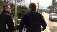 TV reporter walks into sign post