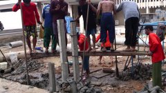 Thai construction workers dance on a beam