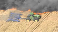 Farmer digs fire line with tractor to stop wild raging fire
