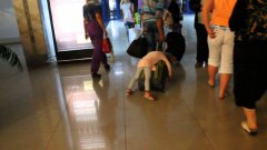 Russian girl sleeps on luggage as dad walks through airport