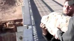 Dropping a 100 lb rock 467 ft off a bridge onto a frozen river