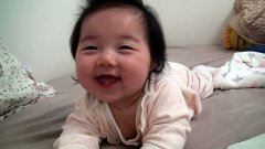 Cute sleepy baby smiles